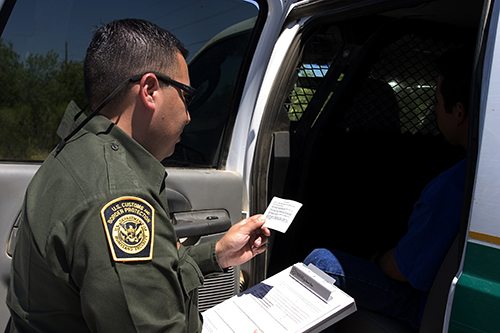 Border Patrol agents reads the Miranda rights to a Mexican national arrested for transporting drugs.